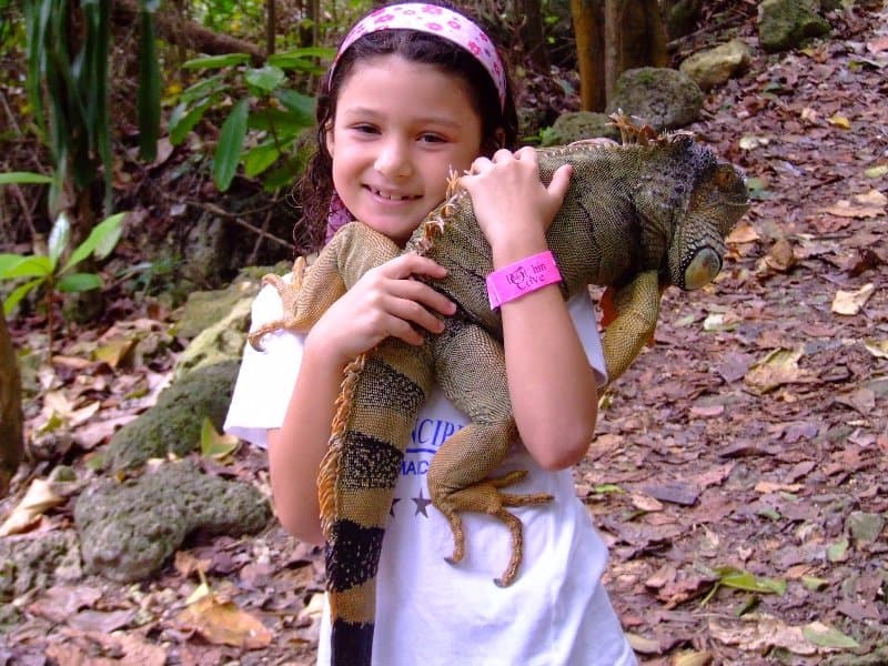 Isn't she a cutie. Holding an Iguana at Dolphin Cove!