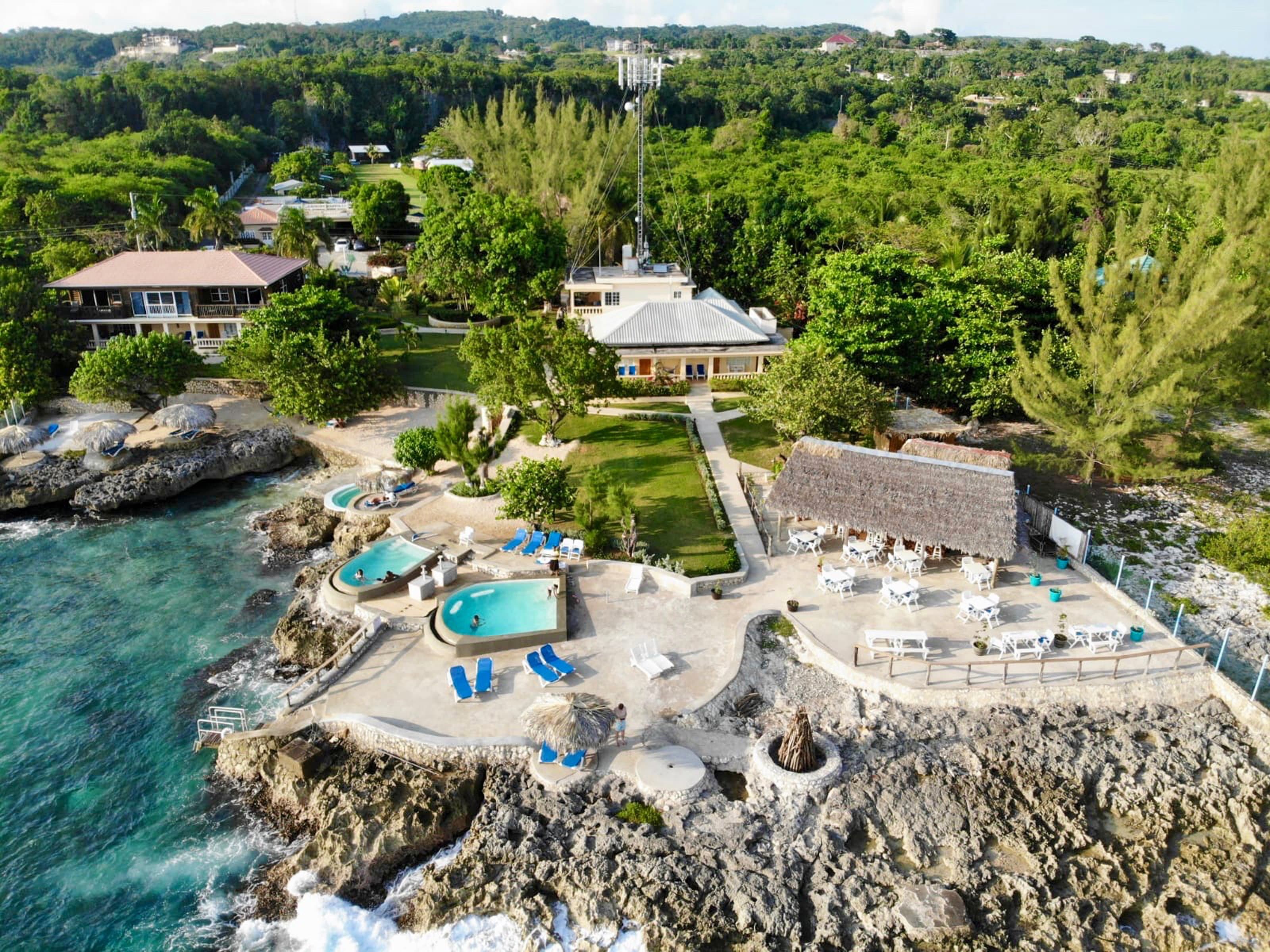 Westender Inn Oceanside Rooms + Suites, sundeck, pools, restaurant and bar.  Garden Cottages can be seen in the top of the photo.