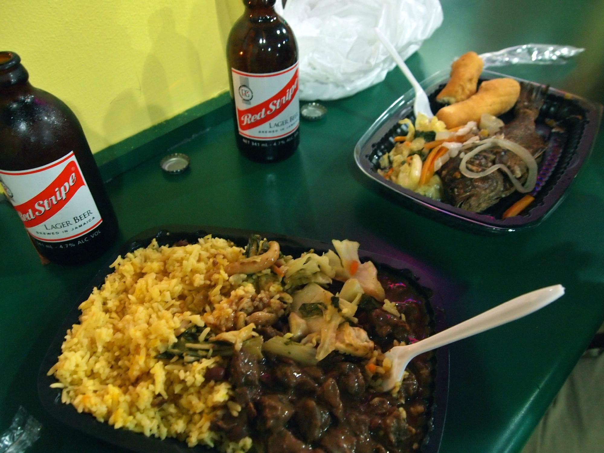 Rice and peas and fish escevitch with festival and Red Stripe beer at Island Grill, in Kingston.
