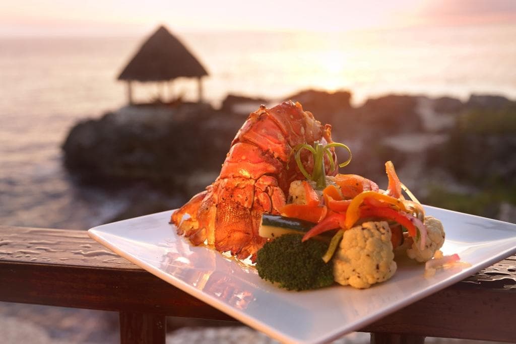Grilled Lobster, with lightly sautéed vegetables, in the Lodge at sunset