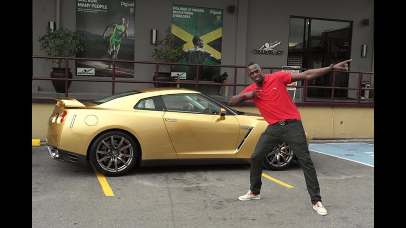 Usain Bolt outside Usain Bolt's Tracks and Records Kingston