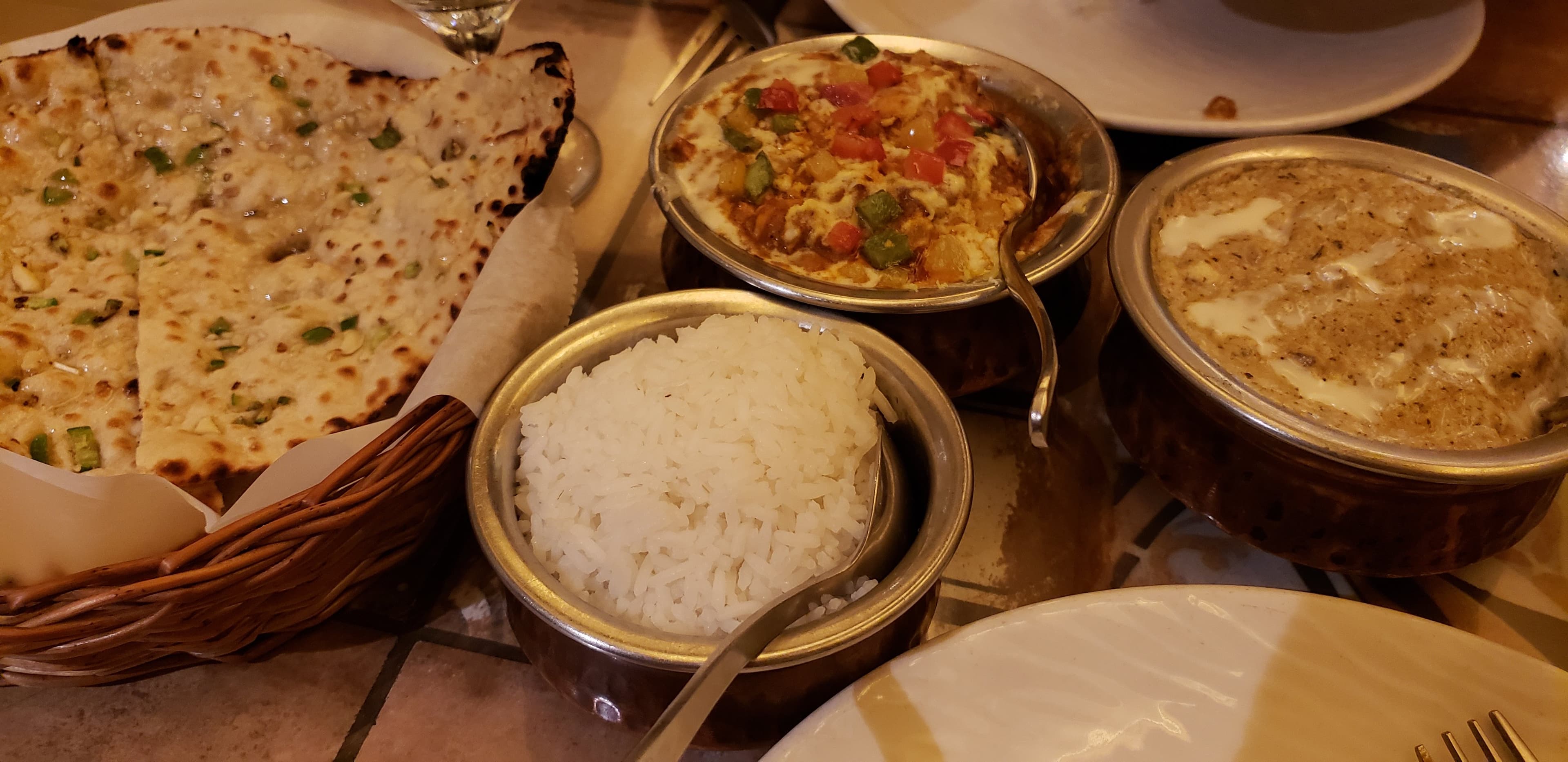 Chicken Curry, Methi Malai Paneer, Chilli Garlic Naan, Rice served with the curries..