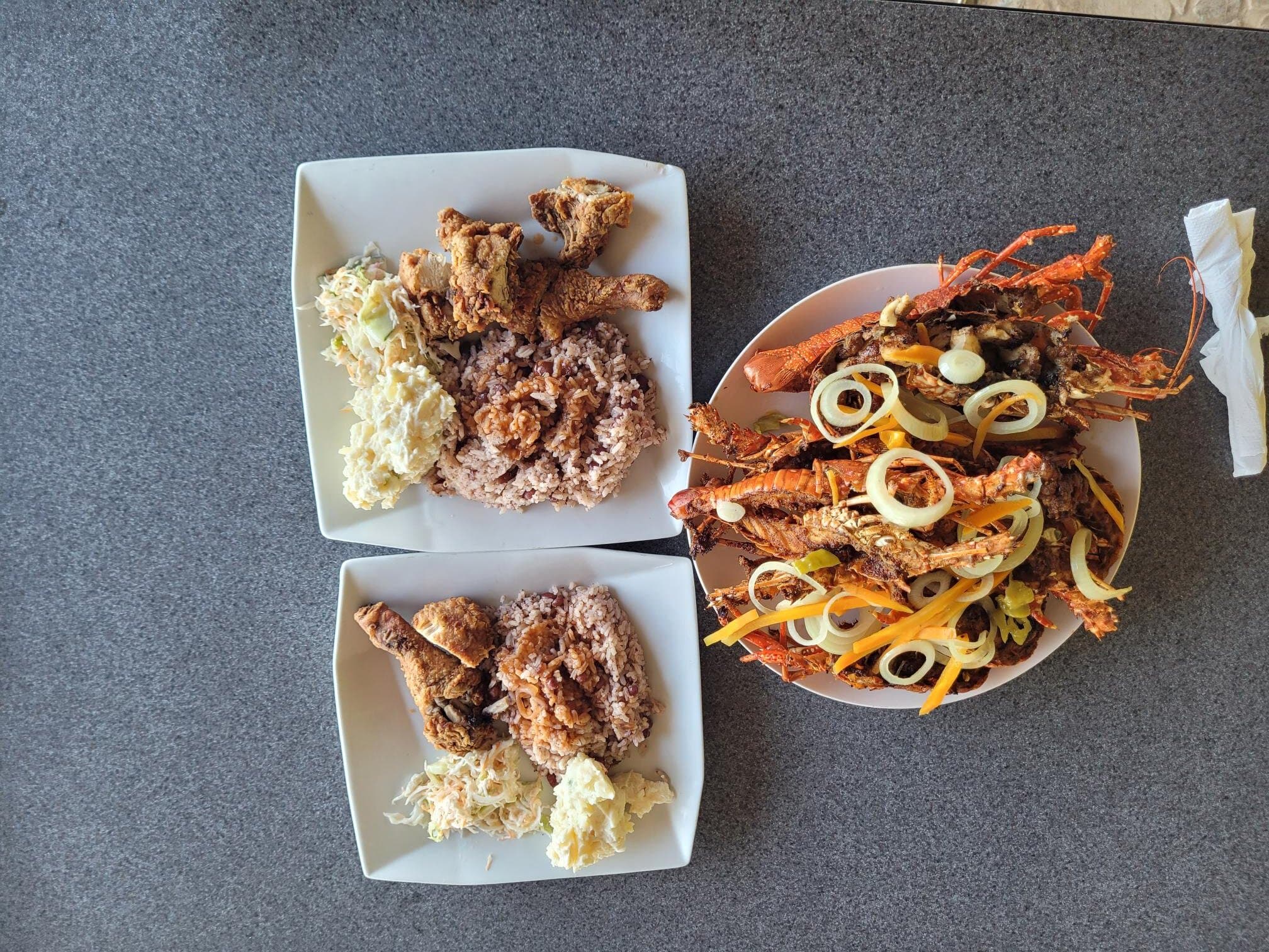 Lobster, Fried chicken, rice & peas, and potato salad